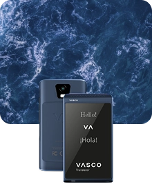 Two blue Vasco Translators Q1 shown from the front and back against a dark, textured ocean water background. The front screen displays 