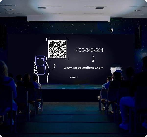 A large conference room screen displays the “Join Vasco Audience” instructions, showing guidance for participants on how to access the session.